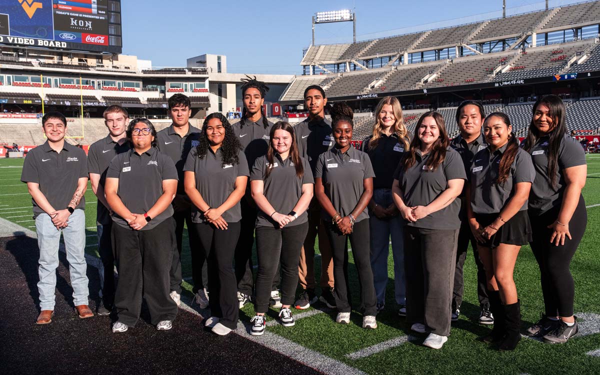 FANgineers posing as a group on the football field